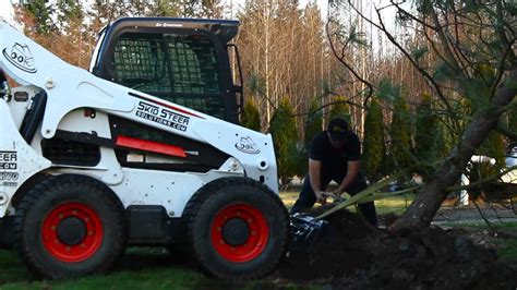 digging trees with skid steer|eterra tree spade skid steer.